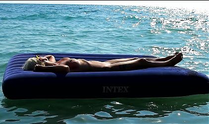 I watched on the beach how a naked girl with big tits was sunbathing on a mattress. Slow motion